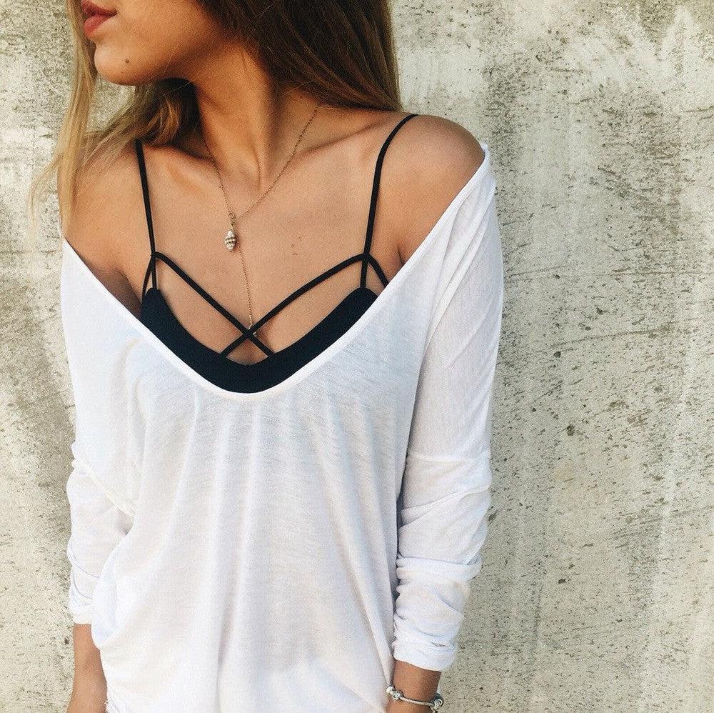 Black strappy bralette with loose white top